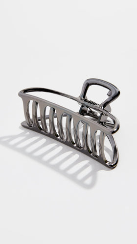 Kitsch Open Shape Metal Hair Clip in hematite, on a vanity