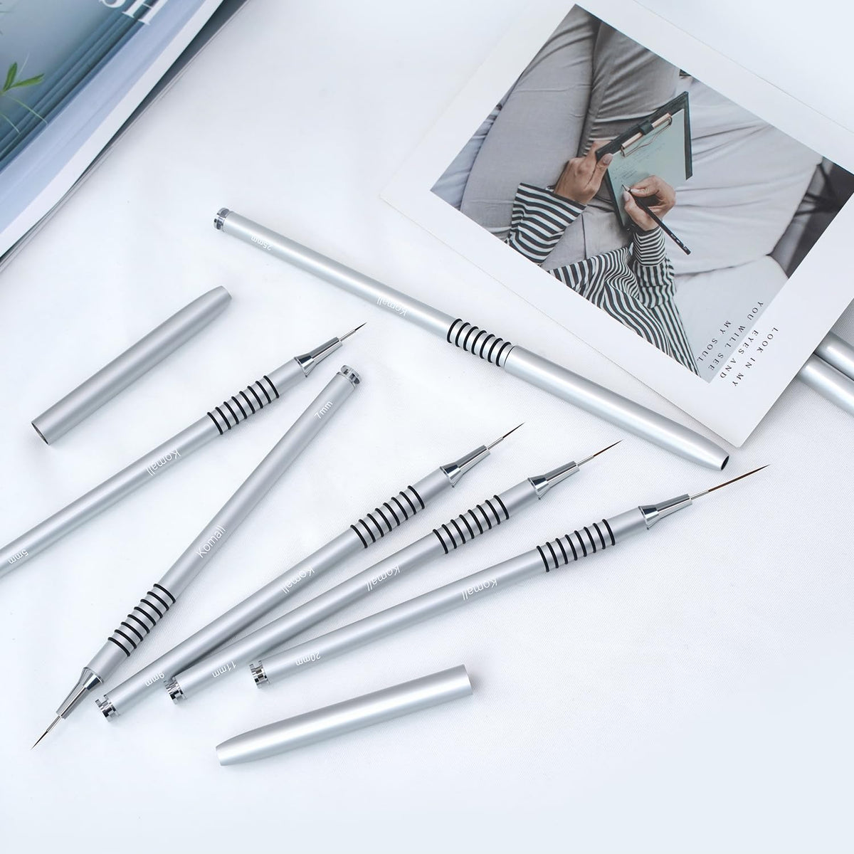 Komall Nail Art Brushes Set laid out on a nail art table