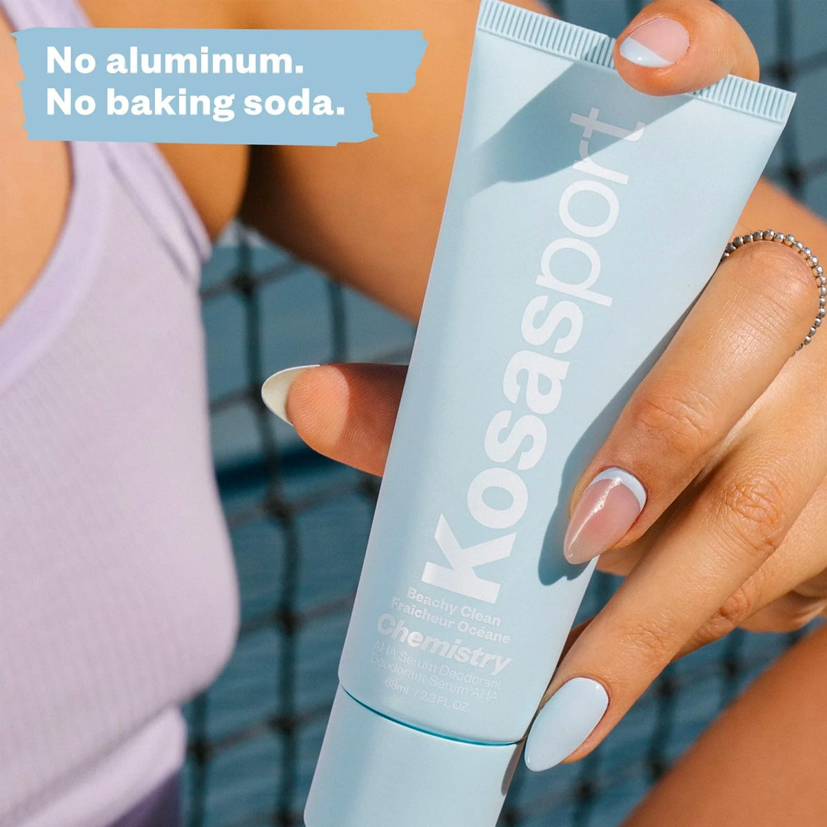 Kosas Chemistry AHA Serum Deodorant with fresh flowers background
