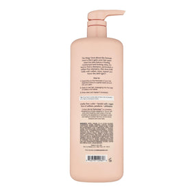 Kristin Ess Hair One Signature Shampoo bottle with floral fragrance notes