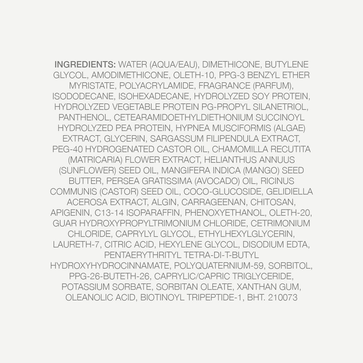 Kristin Ess Hair Weightless Shine Air Dry Cream with floral background