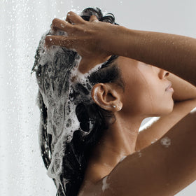 Kristin Ess shampoo in bathroom setting