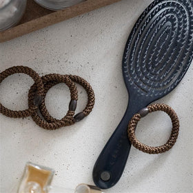 L. Erickson hair ties displayed on a stylish background
