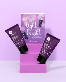 L LUSETA Purple Travel Shampoo and Conditioner Mini Kit on a bathroom shelf