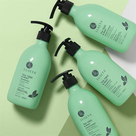 L LUSETA Tea Tree Mint Shampoo and Conditioner set on a wooden table