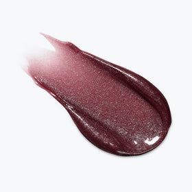 L'Oreal Paris Plump Ambition Lip Oil Ruby Lights in a makeup bag
