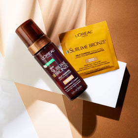 L'Oreal Paris Sublime Bronze Self Tanning Towelettes held in hand