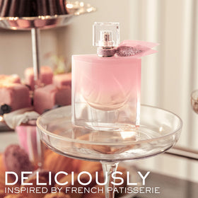 Lancôme La Vie Est Belle Vanille Nude Eau de Parfum bottle with floral background