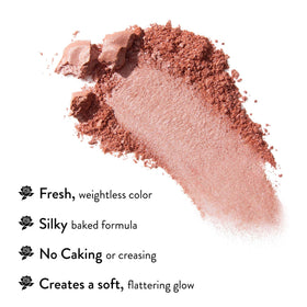 LAURA GELLER Baked Blush-n-Brighten on a makeup table