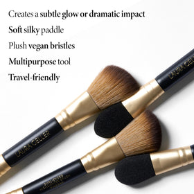 LAURA GELLER Dual-Ended Highlighter Brush on makeup table