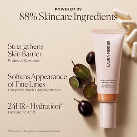 Laura Mercier Tinted Moisturizer on vanity with flowers