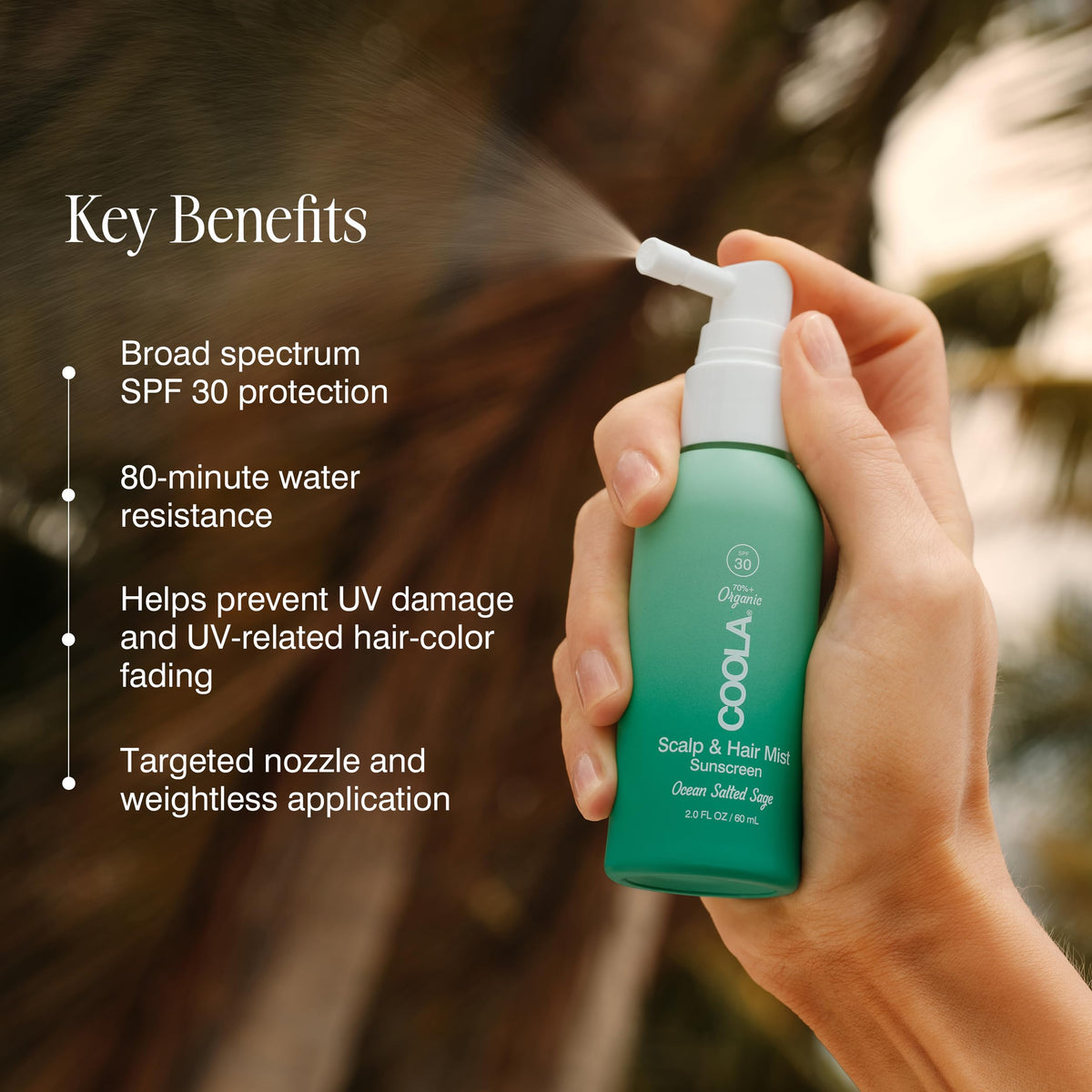 Lifestyle image of COOLA Scalp Spray on a beach