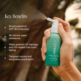 Lifestyle image of COOLA Scalp Spray on a beach