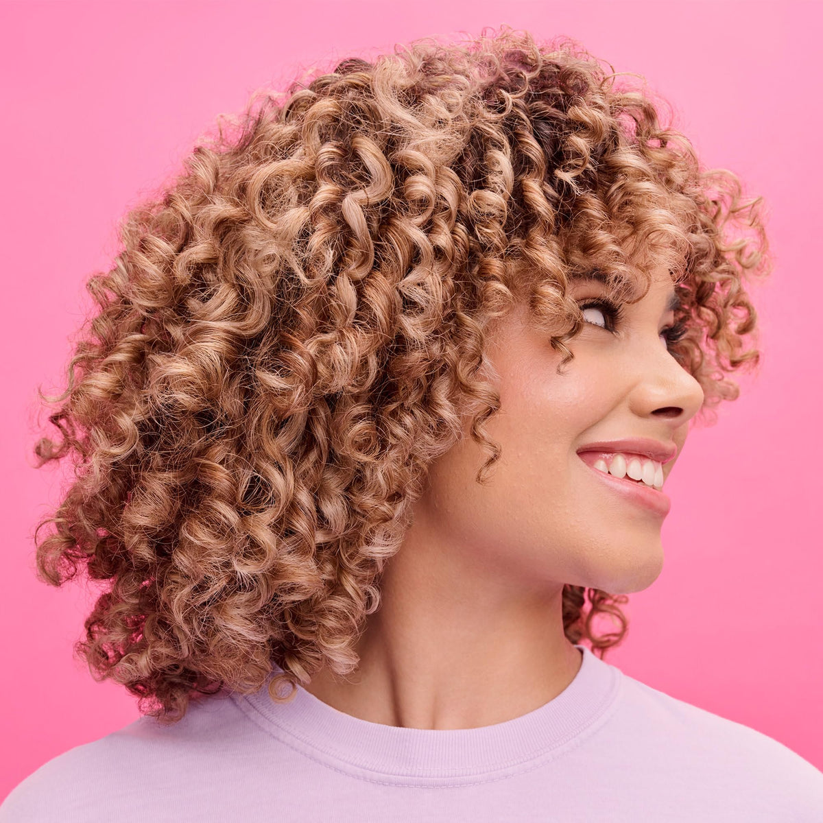 Lifestyle image of Not Your Mother's Curl Defining Shampoo and Conditioner in bathroom
