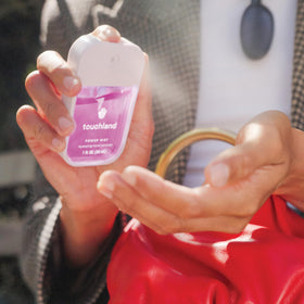 Lifestyle scene using Touchland Juicy 5 Hand Sanitizer Spray Set outdoors