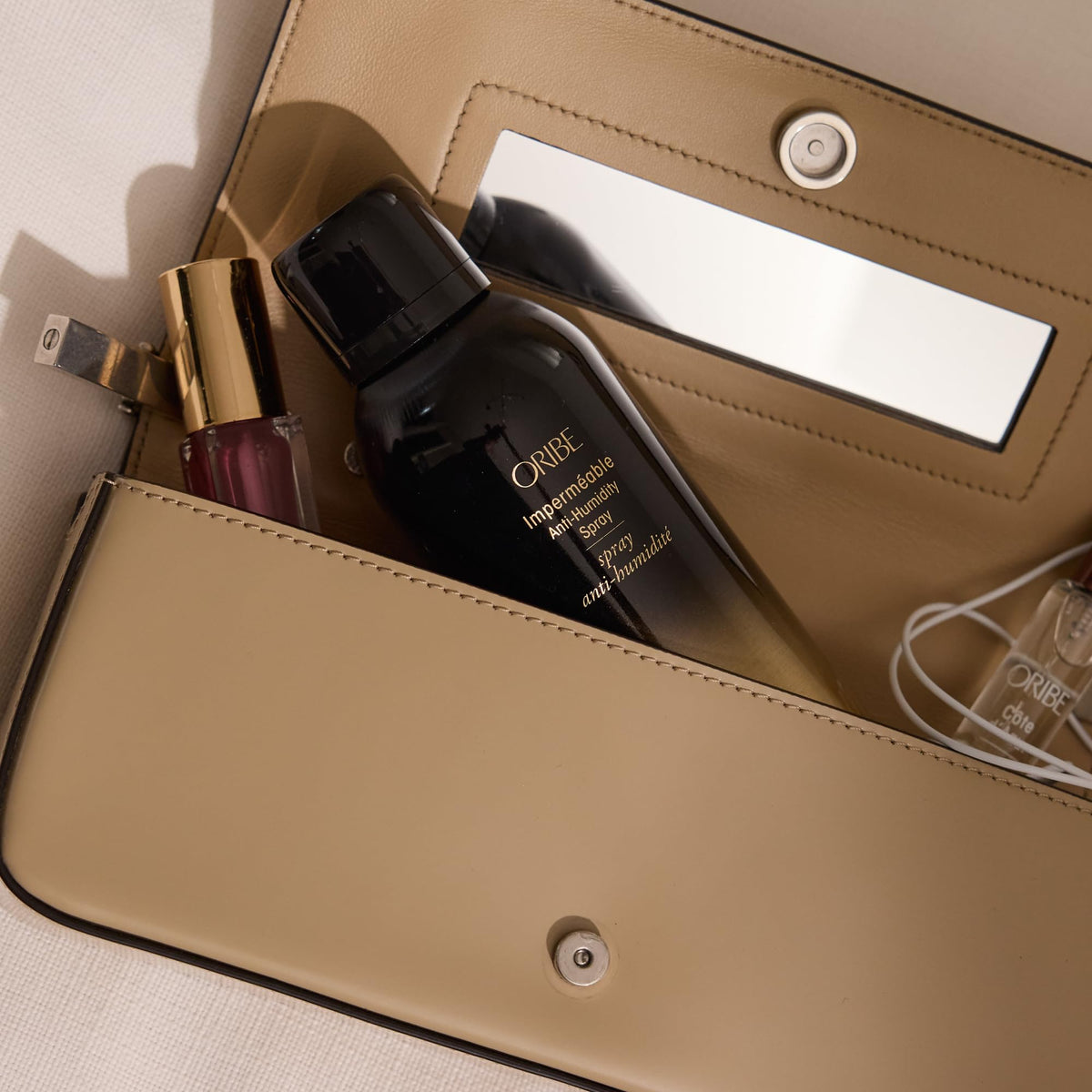 Lifestyle scene with ORIBE Impermeable Anti-Humidity Spray 2.2oz