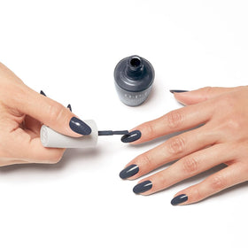 Lifestyle shot of OPI Nature Strong Dark Blue Nail Polish in use