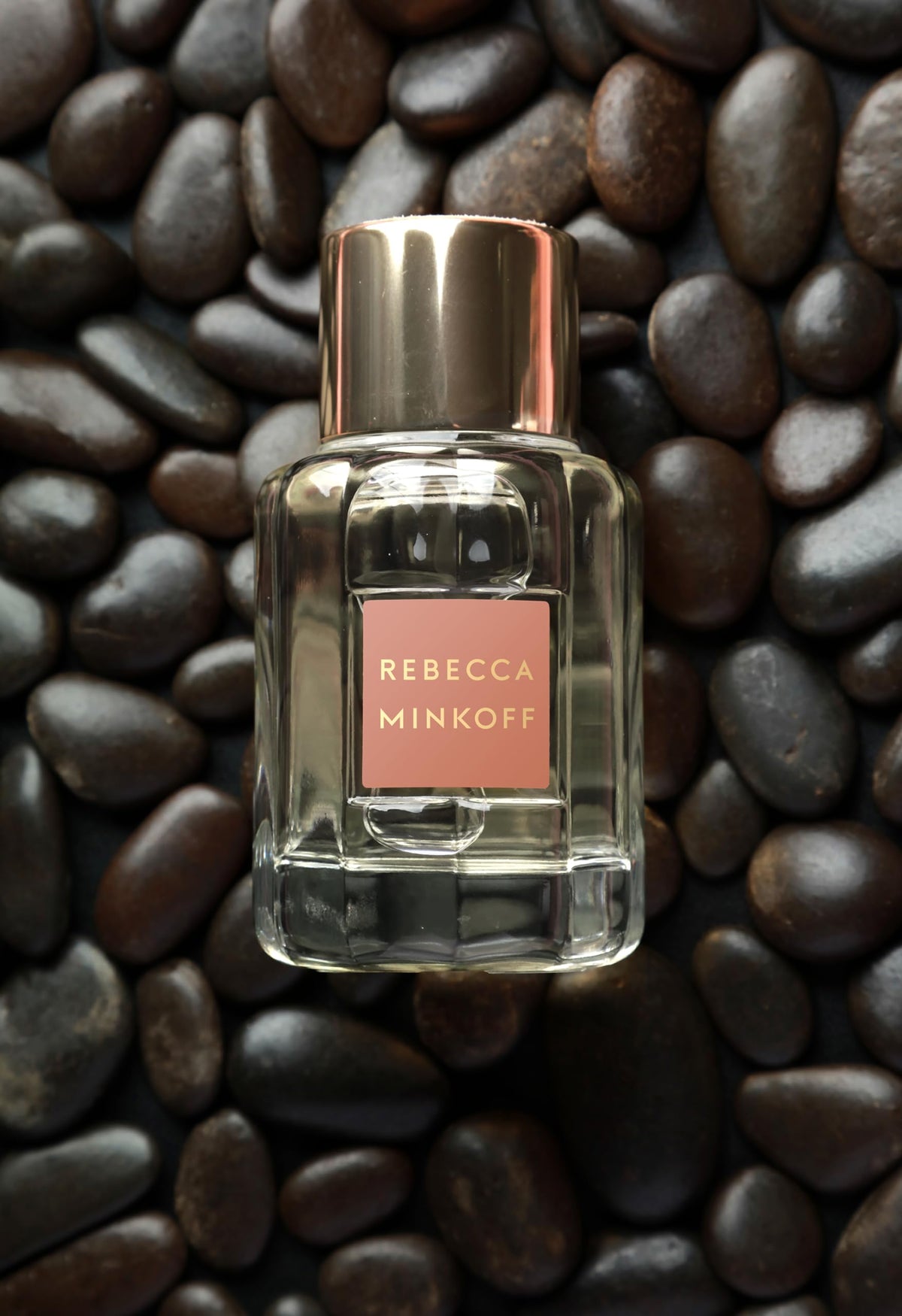 Lifestyle shot of Rebecca Minkoff Blush being sprayed on wrist