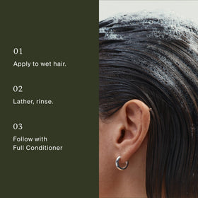 Living Proof Full Shampoo 2 oz with a fresh floral background