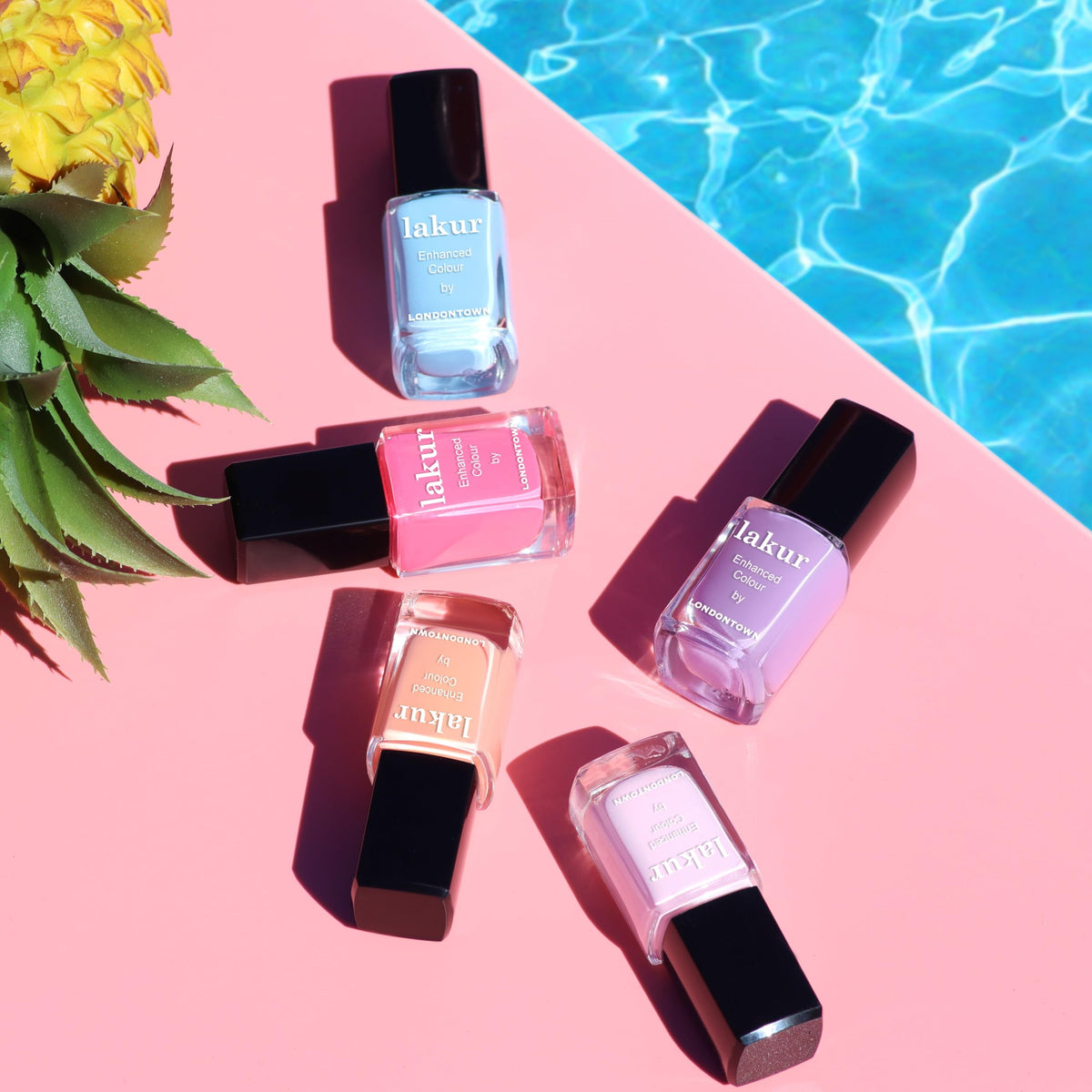 LONDONTOWN lakur Nail Polish Pink Palm on a manicure table