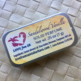 Love from Santa Barbara Sandalwood Vanilla Solid Perfume on a makeup table