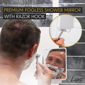 Luxo Shower Mirror mounted on a glass shower wall
