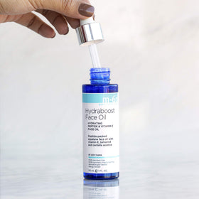 m-61 Hydraboost Face Oil 1 Fl Oz on a bathroom counter