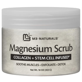 M3 Naturals Magnesium Body Scrub 16oz next to a towel and candles