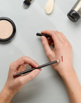 MAC Lip Pencil Mahogany in a makeup bag