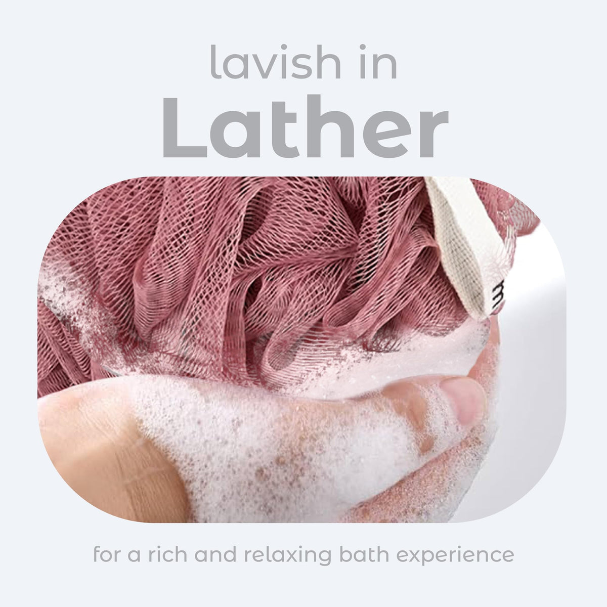 MainBasics loofah sponges in coral reef shades on a bathroom shelf