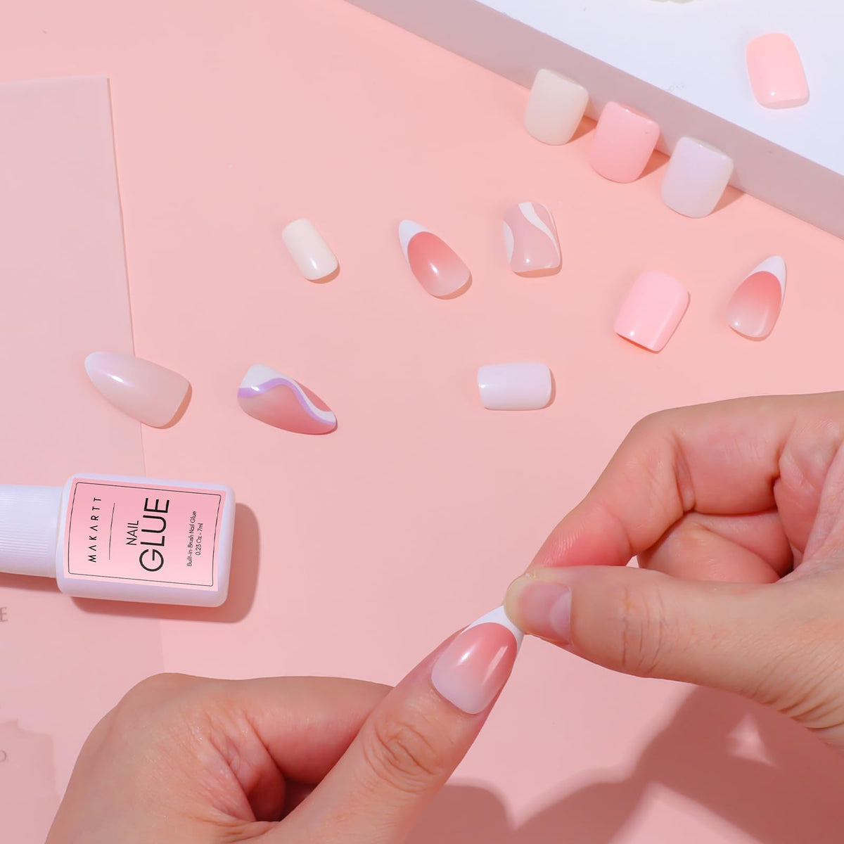 Makartt Brush-On Nail Glue 7ML on a table with nails