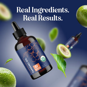 Maple Holistics Organic Tamanu Oil with a towel and flowers