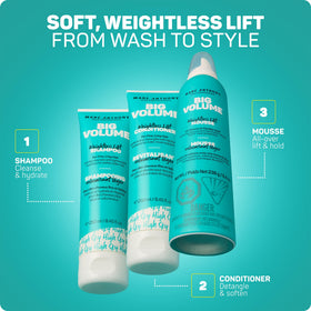 Marc Anthony Big Volume Mousse on a bathroom shelf with hair tools
