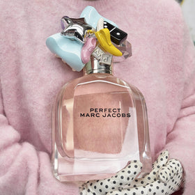 Marc Jacobs Perfect Eau de Parfum on a vanity with flowers