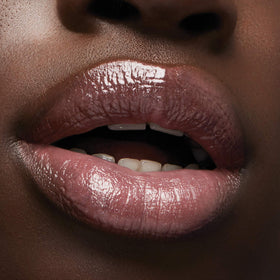 Milani Lip Gloss Keep It Full Luminoso in hand