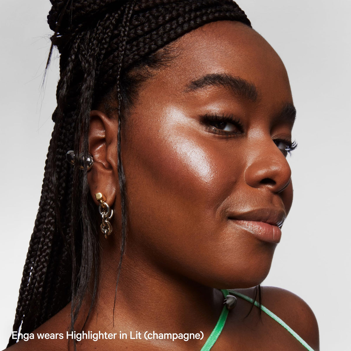 Milk Makeup Highlighter Stick Lit in a lifestyle setting