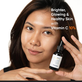 Minimalist Vitamin C Serum dropper with serum on fingertips