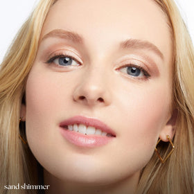 Model applying Julep Eyeshadow 101 Stick in Sand Shimmer
