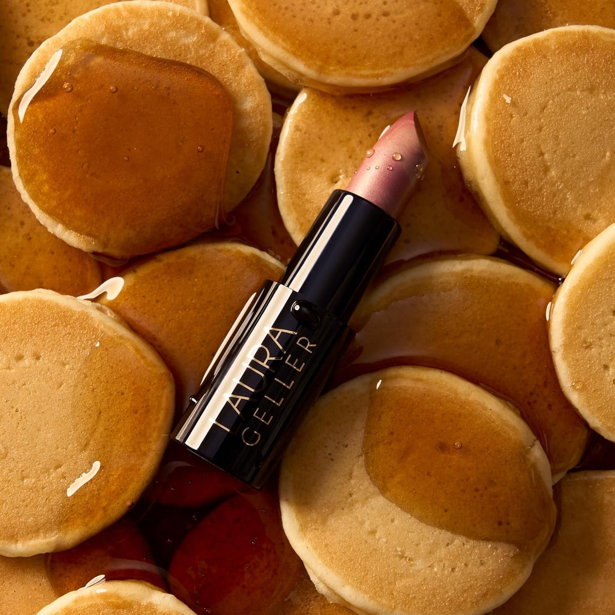 Model applying LAURA GELLER Italian Marble lipstick in Sugared Maple