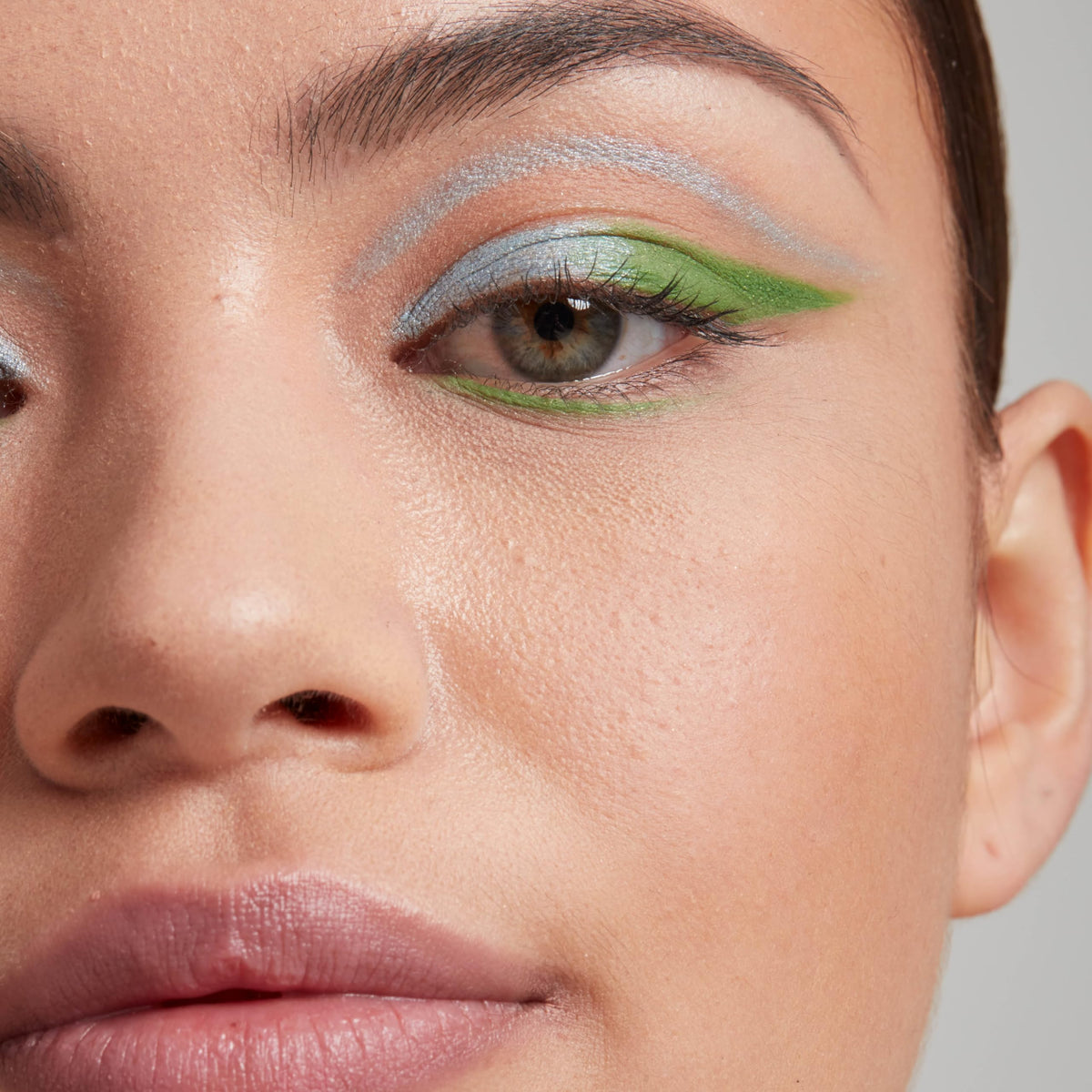 Model applying NYX Epic Wear Liner Stick in Emerald Cut