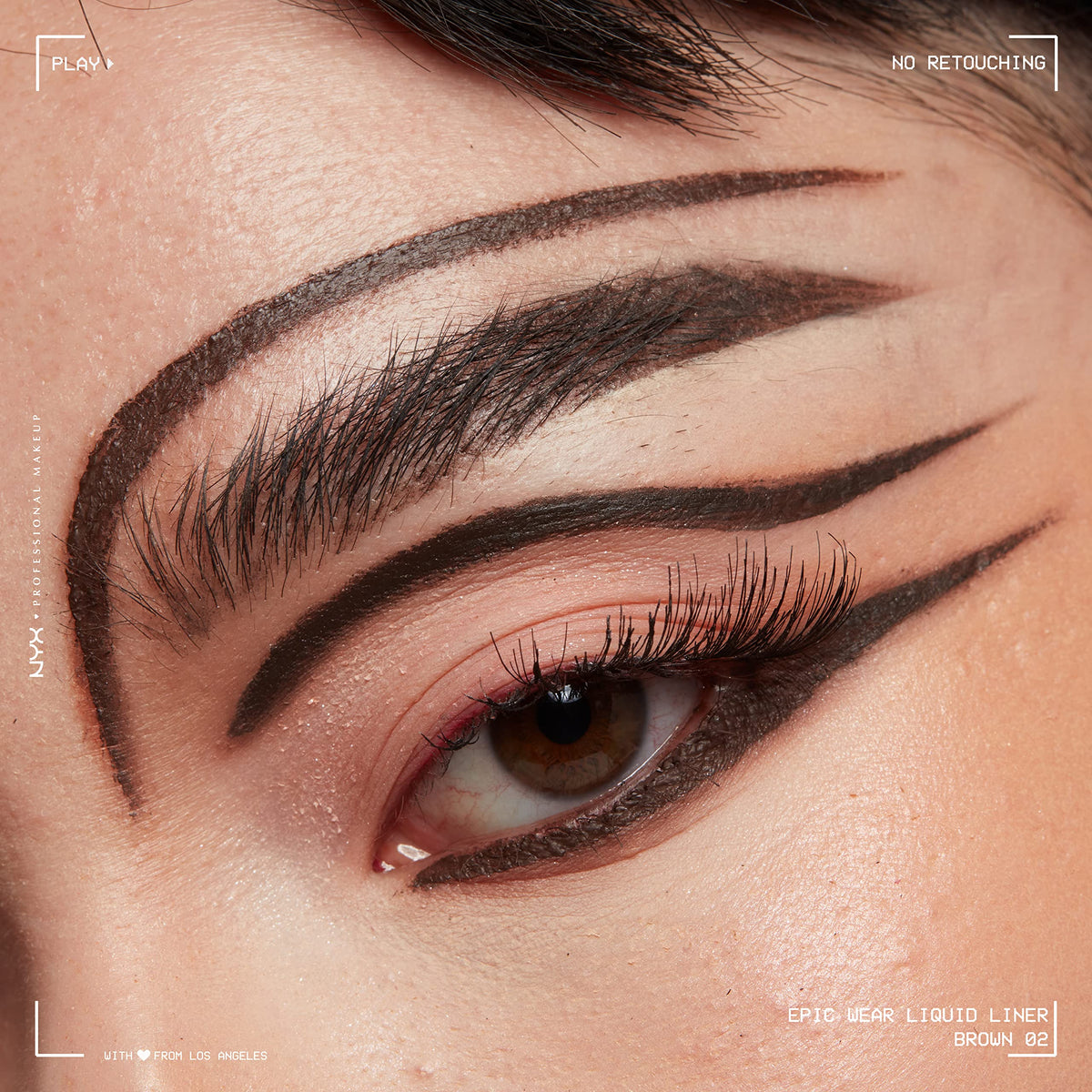 Model applying NYX Epic Wear Liquid Liner to eyes