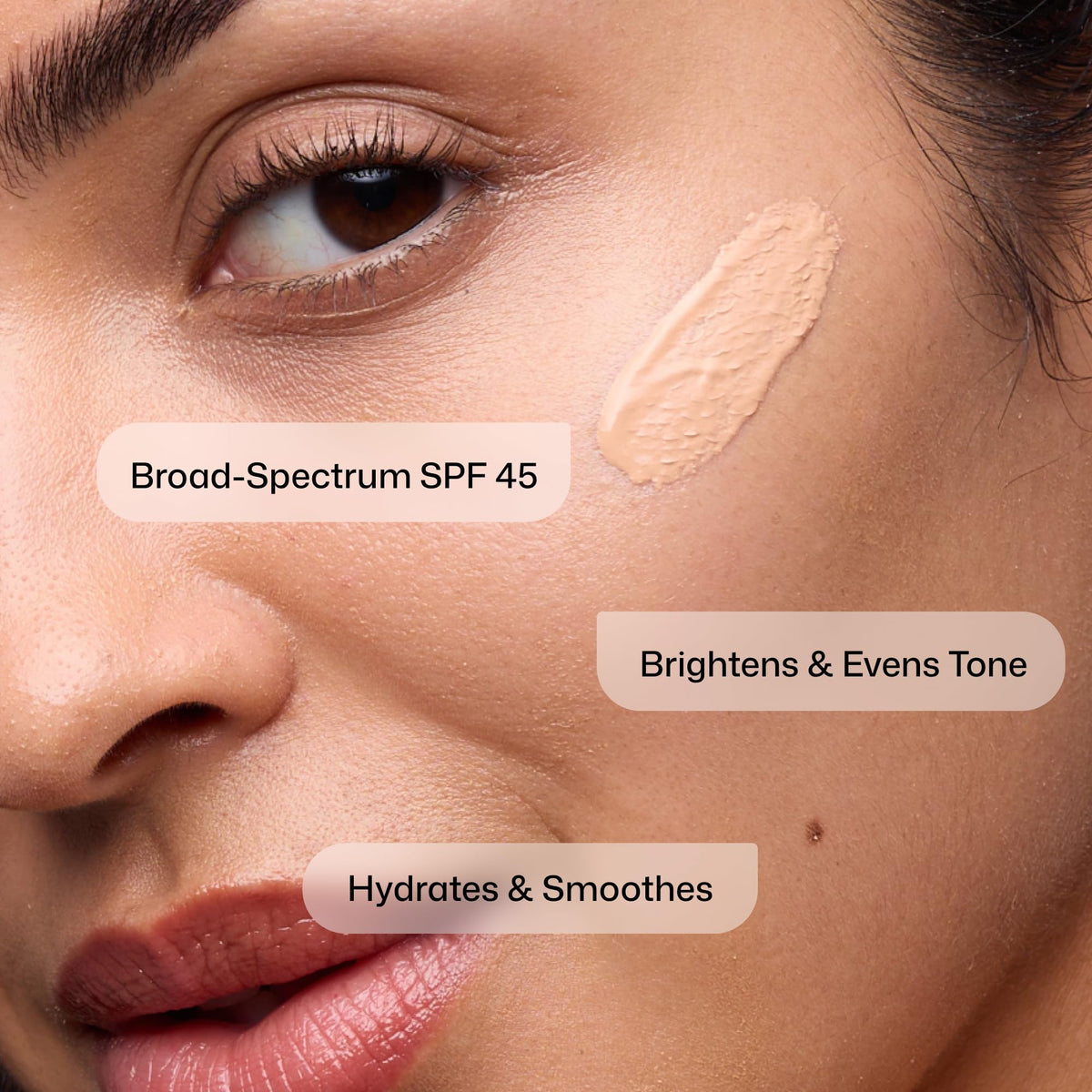 Model applying Revision Skincare Intellishade® Original Tinted Sunscreen SPF 45