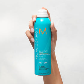 Moroccanoil Dry Texture Spray 5.4 Fl. Oz. on a vanity