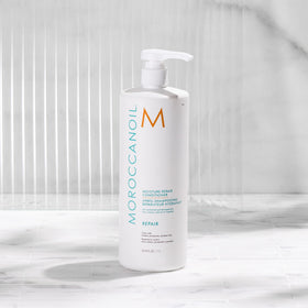 Moroccanoil Moisture Repair Conditioner in a bathroom setting