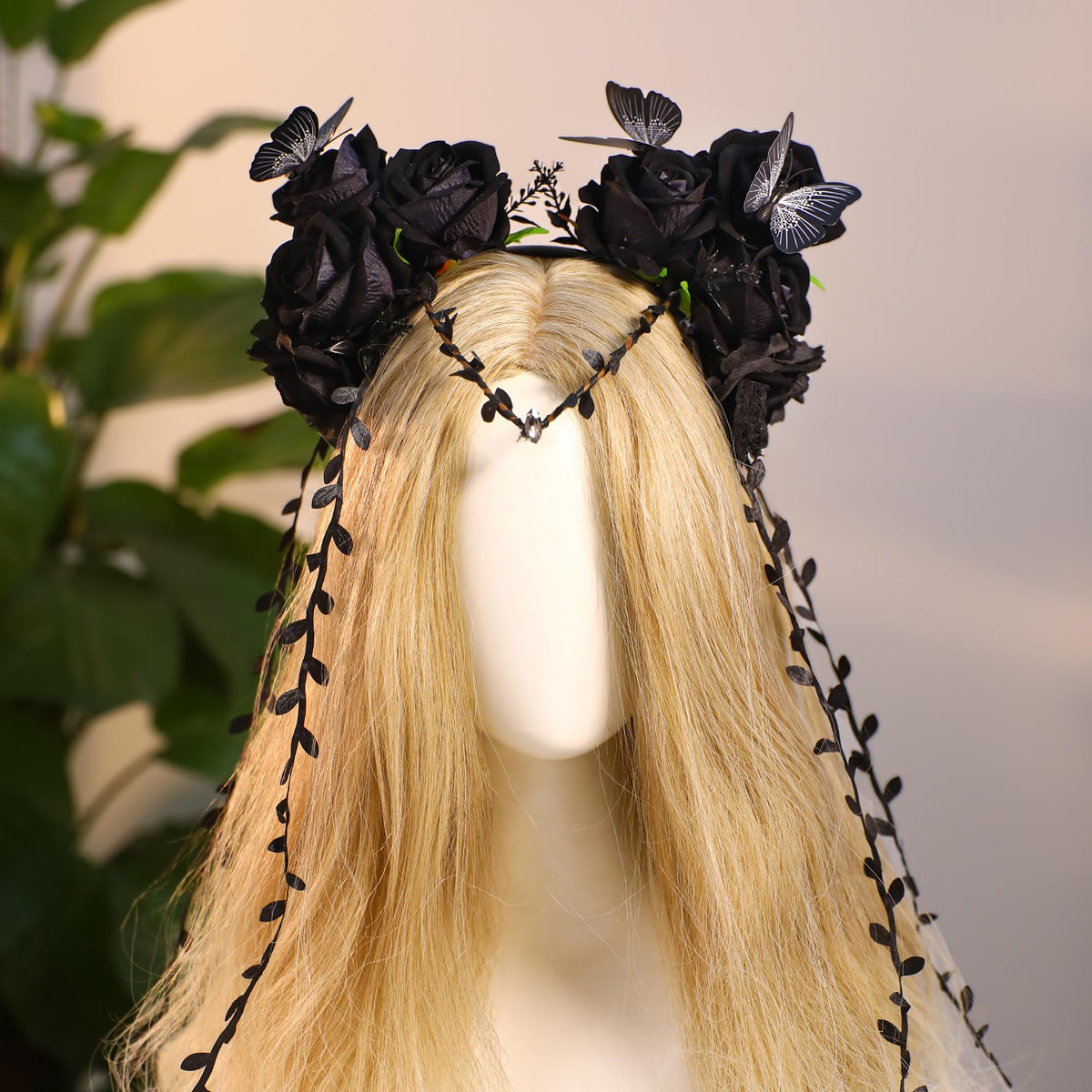 MOSTORY Black Flower Crown Headband displayed on a decorative stand