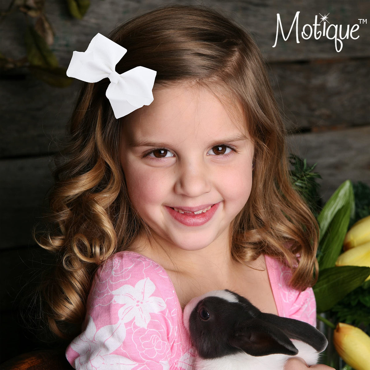 Motique Accessories Grosgrain Bow Clip displayed with colourful outfits