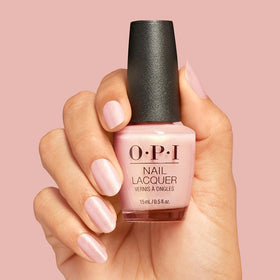 Nails painted with OPI Reoccurin' Gleam in a stylish setting
