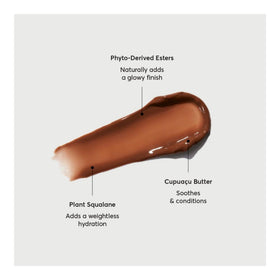 Naturium Phyto-Glow Lip Balm on a wooden table