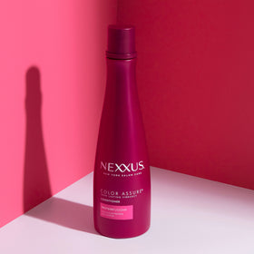 Nexxus Color Assure Shampoo and Conditioner set on a bathroom shelf