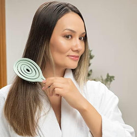 Ninabella Detangler Brush displayed on a bathroom counter